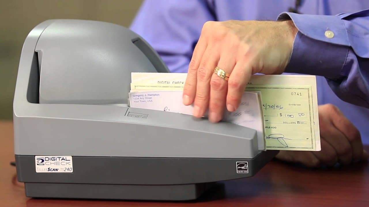 Digital Check TellerScan TS240 scanning checks at a bank teller station