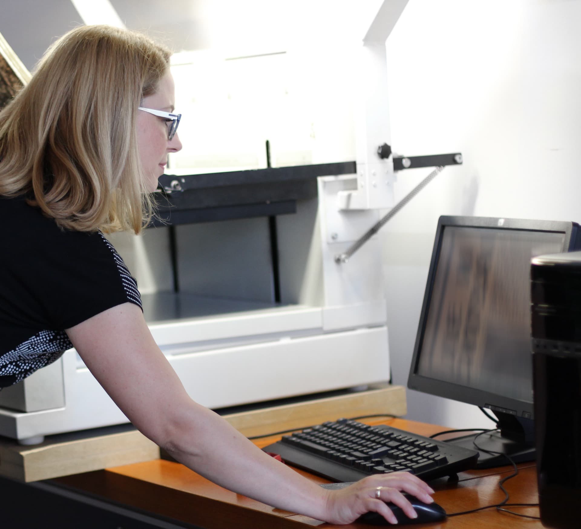 Document conversion specialist operating scanning and indexing equipment