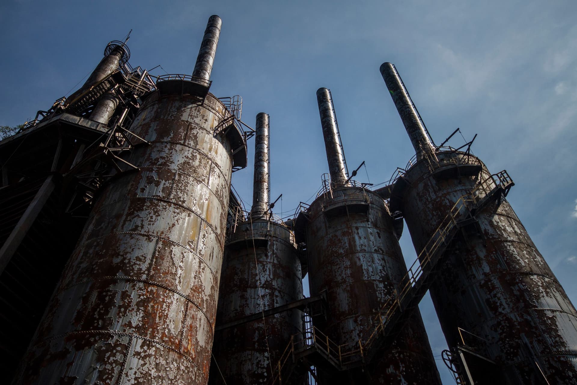 Low-angle view of the rusted blast-furnace stacks of the former Bethlehem Steel plant against a blue sky — Bethlehem, PA