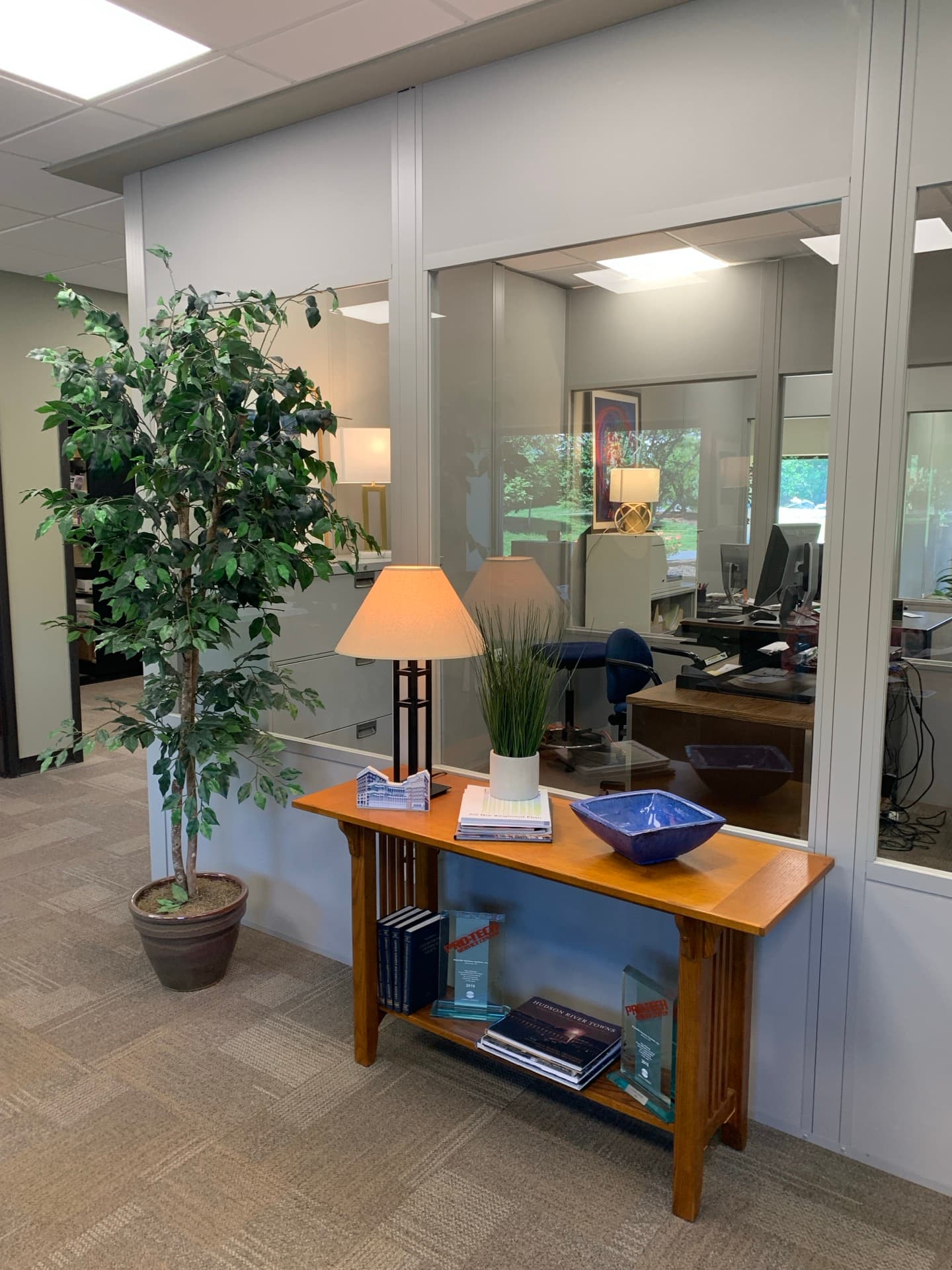Modular panel walls forming an enclosed office inside a facility.