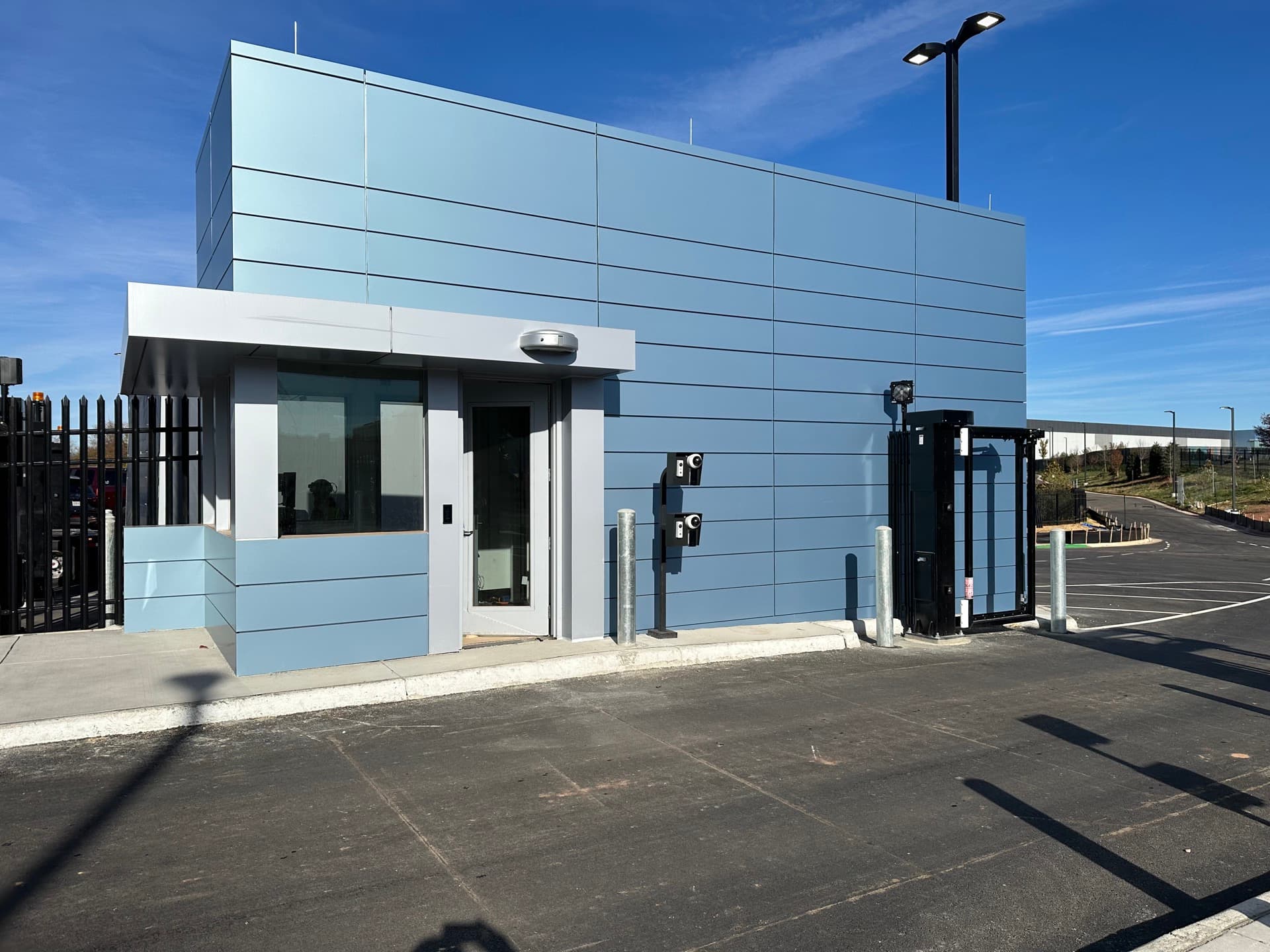 Exterior modular security gatehouse at an industrial facility.