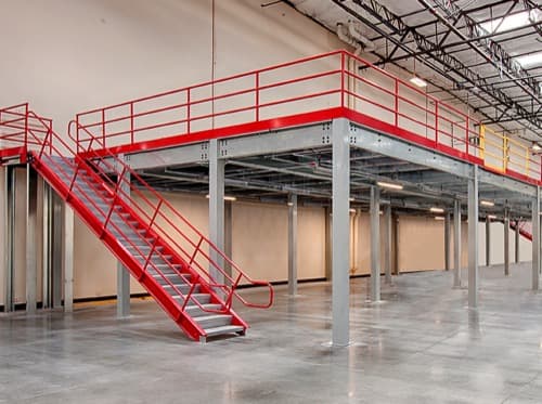 Structural steel mezzanine with safety railing in a warehouse