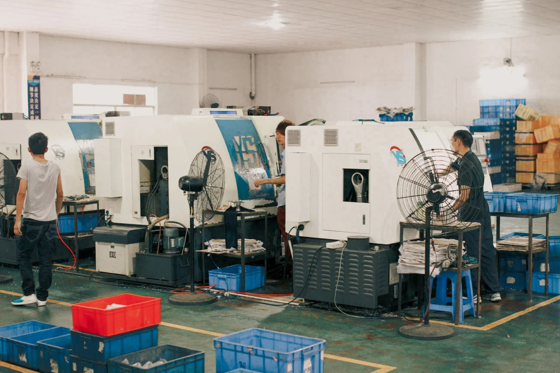 Production team coordinating work across an active manufacturing operation