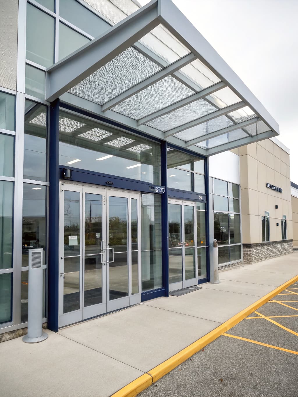 Architectural detail of a modern glass-and-aluminum entrance vestibule