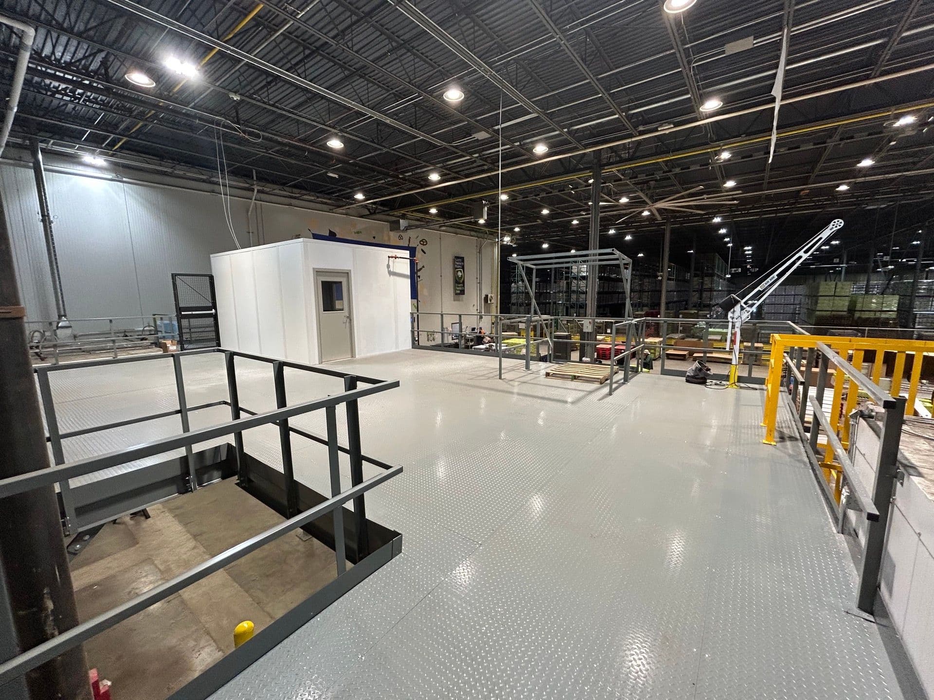 Steel mezzanine and modular office installed on a manufacturing floor